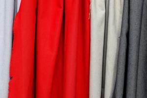 Detailed close up view on samples of cloth and fabrics in different colors found at a fabrics market photo