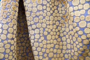 Detailed close up view on samples of cloth and fabrics in different colors found at a fabrics market photo