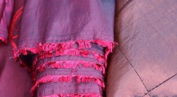 Detailed close up view on samples of cloth and fabrics in different colors found at a fabrics market photo