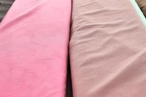 Detailed close up view on samples of cloth and fabrics in different colors found at a fabrics market photo