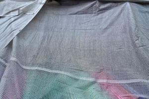 Detailed close up view on samples of cloth and fabrics in different colors found at a fabrics market photo