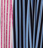 Detailed close up view on samples of cloth and fabrics in different colors found at a fabrics market photo