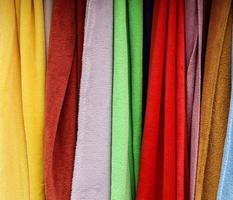 Detailed close up view on samples of cloth and fabrics in different colors found at a fabrics market photo