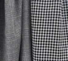 Detailed close up view on samples of cloth and fabrics in different colors found at a fabrics market photo