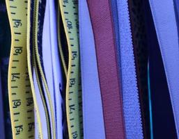Detailed close up view on samples of cloth and fabrics in different colors found at a fabrics market photo