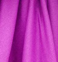 Detailed close up view on samples of cloth and fabrics in different colors found at a fabrics market photo