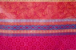 Detailed close up view on samples of cloth and fabrics in different colors found at a fabrics market photo