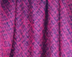 Detailed close up view on samples of cloth and fabrics in different colors found at a fabrics market photo