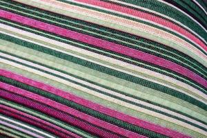 Detailed close up view on samples of cloth and fabrics in different colors found at a fabrics market photo