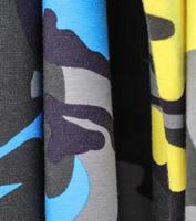 Detailed close up view on samples of cloth and fabrics in different colors found at a fabrics market photo