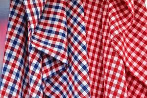 Detailed close up view on samples of cloth and fabrics in different colors found at a fabrics market photo