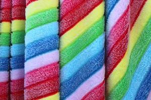 Detailed close up view on samples of cloth and fabrics in different colors found at a fabrics market photo