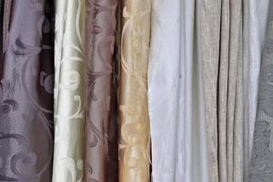 Detailed close up view on samples of cloth and fabrics in different colors found at a fabrics market photo