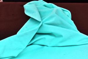 Detailed close up view on samples of cloth and fabrics in different colors found at a fabrics market photo