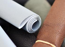 Detailed close up view on samples of cloth and fabrics in different colors found at a fabrics market photo