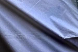 Detailed close up view on samples of cloth and fabrics in different colors found at a fabrics market photo