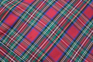 Detailed close up view on samples of cloth and fabrics in different colors found at a fabrics market photo