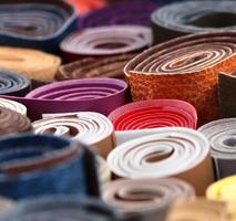 Detailed close up view on samples of cloth and fabrics in different colors found at a fabrics market photo