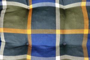 Detailed close up view on samples of cloth and fabrics in different colors found at a fabrics market photo