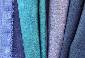 Detailed close up view on samples of cloth and fabrics in different colors found at a fabrics market photo