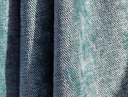 Detailed close up view on samples of cloth and fabrics in different colors found at a fabrics market photo