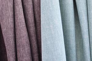 Detailed close up view on samples of cloth and fabrics in different colors found at a fabrics market photo