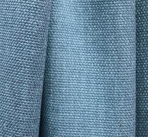 Detailed close up view on samples of cloth and fabrics in different colors found at a fabrics market photo