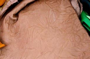 Detailed close up view on samples of cloth and fabrics in different colors found at a fabrics market photo