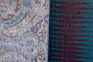 Detailed close up view on samples of cloth and fabrics in different colors found at a fabrics market photo
