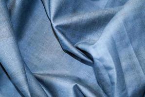 Detailed close up view on samples of cloth and fabrics in different colors found at a fabrics market photo