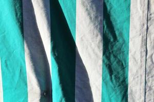 Detailed close up view on samples of cloth and fabrics in different colors found at a fabrics market photo