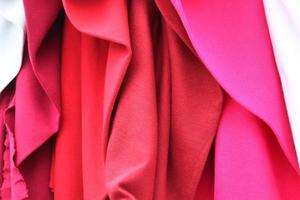 Detailed close up view on samples of cloth and fabrics in different colors found at a fabrics market photo