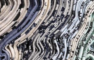 Detailed close up view on samples of cloth and fabrics in different colors found at a fabrics market photo