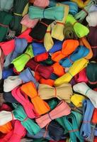 Detailed close up view on samples of cloth and fabrics in different colors found at a fabrics market photo
