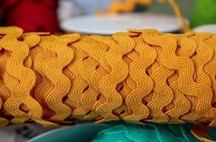 Detailed close up view on samples of cloth and fabrics in different colors found at a fabrics market photo