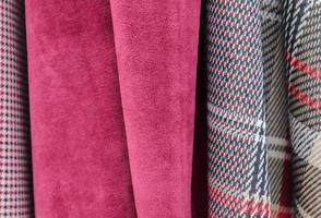 Detailed close up view on samples of cloth and fabrics in different colors found at a fabrics market photo