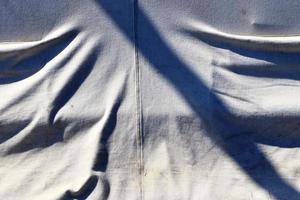 Detailed close up view on samples of cloth and fabrics in different colors found at a fabrics market photo