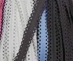 Detailed close up view on samples of cloth and fabrics in different colors found at a fabrics market photo