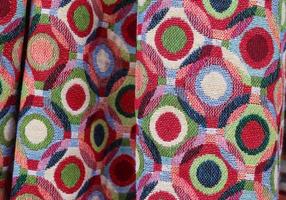 Detailed close up view on samples of cloth and fabrics in different colors found at a fabrics market photo