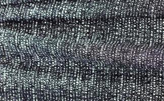 Detailed close up view on samples of cloth and fabrics in different colors found at a fabrics market photo