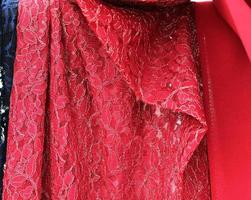 Detailed close up view on samples of cloth and fabrics in different colors found at a fabrics market photo