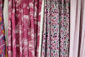 Detailed close up view on samples of cloth and fabrics in different colors found at a fabrics market photo