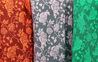 Detailed close up view on samples of cloth and fabrics in different colors found at a fabrics market photo