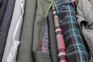 Detailed close up view on samples of cloth and fabrics in different colors found at a fabrics market photo