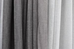 Detailed close up view on samples of cloth and fabrics in different colors found at a fabrics market photo
