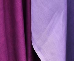 Detailed close up view on samples of cloth and fabrics in different colors found at a fabrics market photo