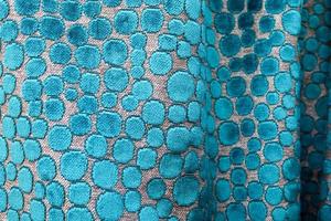 Detailed close up view on samples of cloth and fabrics in different colors found at a fabrics market photo