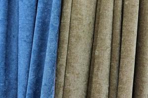 Detailed close up view on samples of cloth and fabrics in different colors found at a fabrics market photo