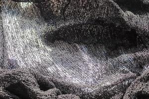 Detailed close up view on samples of cloth and fabrics in different colors found at a fabrics market photo