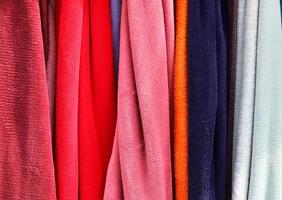 Detailed close up view on samples of cloth and fabrics in different colors found at a fabrics market photo